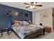 Comfortable bedroom featuring a blue accent wall, ceiling fan, and a cozy quilt-covered bed at 594 N Shore Blvd, Franklin, IN 46131