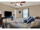 Bedroom featuring a window with curtains, ceiling fan, and an entertainment center with a TV at 594 N Shore Blvd, Franklin, IN 46131