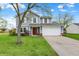 Charming two-story home with a well-maintained lawn, two-car garage, and traditional architectural details at 594 N Shore Blvd, Franklin, IN 46131