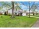Landscaped front yard, two-story home with double-hung windows and a two-car garage with new grass at 594 N Shore Blvd, Franklin, IN 46131