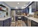 Modern kitchen featuring stainless steel appliances, blue cabinets, and light countertops at 594 N Shore Blvd, Franklin, IN 46131