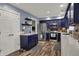 Stylish kitchen features dark blue cabinets, stainless steel appliances, quartz countertops, and luxury vinyl floors at 594 N Shore Blvd, Franklin, IN 46131