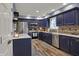 Modern kitchen featuring dark blue cabinets, stainless steel appliances, and tiled backsplash at 594 N Shore Blvd, Franklin, IN 46131