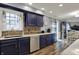 Bright eat-in kitchen with blue cabinets, stainless steel appliances, and hardwood floors at 594 N Shore Blvd, Franklin, IN 46131
