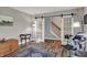 Stylish living room with glass barn doors leading to stairs, modern decor, and wood flooring at 594 N Shore Blvd, Franklin, IN 46131