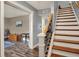 Elegant staircase with wood steps and iron railing, connecting to the home's inviting living spaces at 594 N Shore Blvd, Franklin, IN 46131