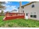 Spacious backyard boasts a large deck, grassy lawn, and mature trees at 6064 Brandermill Rdg, Columbus, IN 47203