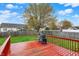 Large backyard features a spacious deck with a grill, mature trees and full perimeter fence at 6064 Brandermill Rdg, Columbus, IN 47203