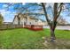 Home exterior with deck and spacious backyard that features mature trees and a full perimeter fence at 6064 Brandermill Rdg, Columbus, IN 47203