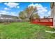 Expansive backyard with a deck, lush green grass, and a full perimeter fence at 6064 Brandermill Rdg, Columbus, IN 47203