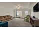 Open basement space with carpet and comfortable seating, suitable for recreational activities or relaxing entertainment at 6064 Brandermill Rdg, Columbus, IN 47203