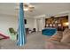 Versatile basement area with a playful touch, includes carpet, seating, a custom bookshelf, and provides access to other rooms at 6064 Brandermill Rdg, Columbus, IN 47203