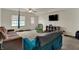 Spacious basement with carpet flooring, ideal for versatile use, featuring ample seating, a TV, and outdoor access at 6064 Brandermill Rdg, Columbus, IN 47203
