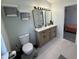 Clean bathroom with a double vanity, modern fixtures, and light tile flooring at 6064 Brandermill Rdg, Columbus, IN 47203