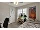Bright bedroom with a large window, plant stand, neutral decor, and natural light at 6064 Brandermill Rdg, Columbus, IN 47203