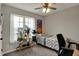 Bright bedroom featuring a single bed, a window with natural light, and simple décor at 6064 Brandermill Rdg, Columbus, IN 47203