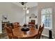 Bright dining room featuring a round wood table, wooden chairs, and a decorative fireplace, offering a warm, inviting space at 6064 Brandermill Rdg, Columbus, IN 47203