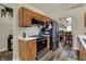 Functional kitchen features stainless steel appliances, wood cabinets, and a view into the adjacent dining area for easy entertaining at 6064 Brandermill Rdg, Columbus, IN 47203