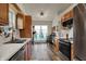 Kitchen features wood cabinets, stainless steel appliances, and a breakfast nook overlooking the yard, creating a cozy culinary space at 6064 Brandermill Rdg, Columbus, IN 47203