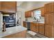 Bright kitchen featuring wood cabinets, stainless steel appliances, and a sink with a window view, enhancing the cooking experience at 6064 Brandermill Rdg, Columbus, IN 47203