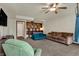 Inviting living room with cozy seating, built-in bookshelves, and a ceiling fan for added comfort at 6064 Brandermill Rdg, Columbus, IN 47203