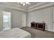 Bright main bedroom with a tray ceiling, neutral decor, and access to the en-suite bathroom at 6064 Brandermill Rdg, Columbus, IN 47203