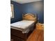 Cozy bedroom features a wooden bed frame and a large window with natural light at 6426 Maple Lawn Rd, Indianapolis, IN 46241