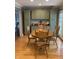 Charming dining area with hardwood floors and traditional wooden table and chairs at 6426 Maple Lawn Rd, Indianapolis, IN 46241
