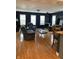 Bright living room with hardwood floors, wood burning stove, and a view to kitchen area at 6426 Maple Lawn Rd, Indianapolis, IN 46241