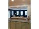 Open-concept living room with blue painted walls with views from kitchen area at 6426 Maple Lawn Rd, Indianapolis, IN 46241