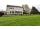 Spacious backyard with lush green lawn and black iron fence, providing a secure and inviting outdoor space at 6518 Sonesta Dr, Indianapolis, IN 46217