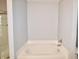 Bright bathroom featuring a soaker tub with tile backsplash at 6518 Sonesta Dr, Indianapolis, IN 46217