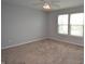 Bright bedroom with plush carpeting, neutral paint, and ample natural light from the windows, creating a serene ambiance at 6518 Sonesta Dr, Indianapolis, IN 46217