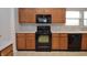 Kitchen with stainless steel appliances, wooden cabinets, and a neutral color palette, creating a modern space at 6518 Sonesta Dr, Indianapolis, IN 46217