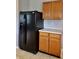 Kitchen featuring a black refrigerator and light wood cabinets, blending style and functionality at 6518 Sonesta Dr, Indianapolis, IN 46217