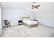 Spacious main bedroom with carpet floors, ceiling fan, and a large bed frame at 6518 Sonesta Dr, Indianapolis, IN 46217