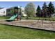 A colorful community playground with a slide, swings, and a soft landing surface at 6518 Sonesta Dr, Indianapolis, IN 46217
