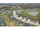 Aerial view of a residential neighborhood featuring houses and a pond, highlighting the community's layout and natural elements at 7391 Blanford Dr, Plainfield, IN 46168