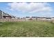 Wide backyard with green grass and a wooden fence, complete with neighboring houses in view at 7391 Blanford Dr, Plainfield, IN 46168