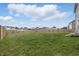 Large fenced backyard with green grass, views of neighboring homes, and providing an ideal outdoor space at 7391 Blanford Dr, Plainfield, IN 46168