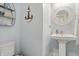 Nautical themed half-bathroom with pedestal sink and coastal decor for a charming ambiance at 7391 Blanford Dr, Plainfield, IN 46168