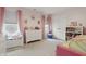 Charming bedroom with pink accents, natural light and white dresser and shelving at 7391 Blanford Dr, Plainfield, IN 46168