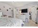 Bright bedroom featuring soft lavender walls, white furniture, and a walk-in closet at 7391 Blanford Dr, Plainfield, IN 46168