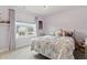 Cozy lavender bedroom with a window view offers a peaceful and charming retreat at 7391 Blanford Dr, Plainfield, IN 46168