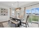 Charming dining area with a wooden table, upholstered chairs, bench seating, and a view of the backyard at 7391 Blanford Dr, Plainfield, IN 46168