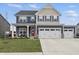 Two-story home with a two-car garage, charming blue shutters, and a cozy front porch at 7391 Blanford Dr, Plainfield, IN 46168
