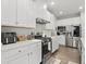Well-lit kitchen featuring white cabinets, stainless steel appliances, and a modern gas range at 7391 Blanford Dr, Plainfield, IN 46168