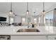 Modern kitchen with a large island, stainless sink, and an open view to the living and dining areas at 7391 Blanford Dr, Plainfield, IN 46168