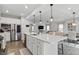 Bright, open kitchen featuring a large island with seating, stainless steel appliances, and pendant lighting at 7391 Blanford Dr, Plainfield, IN 46168