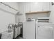 Clean laundry room with white cabinets, a front loading washer and dryer at 7391 Blanford Dr, Plainfield, IN 46168